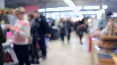 Birçok kişi aydınlatma ile alışveriş merkezi veya mağaza içinde yürümek.