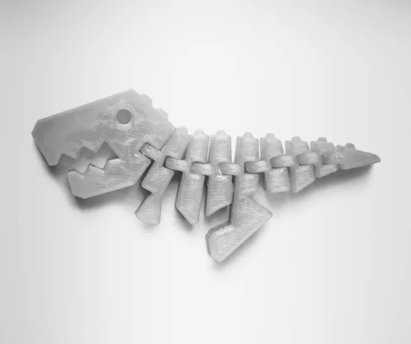 Ljus ljusrosa objekt i form av dinosaurie leksak tryckt på 3D-skrivare — Stockfoto