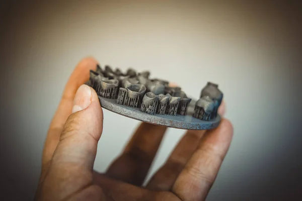 Object printed on metal 3d printer after heat treatment synterization close-up.