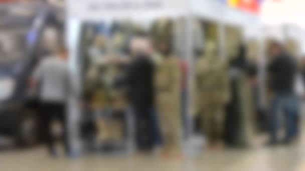 Blurred background. Stand military exhibition. — Stock Video