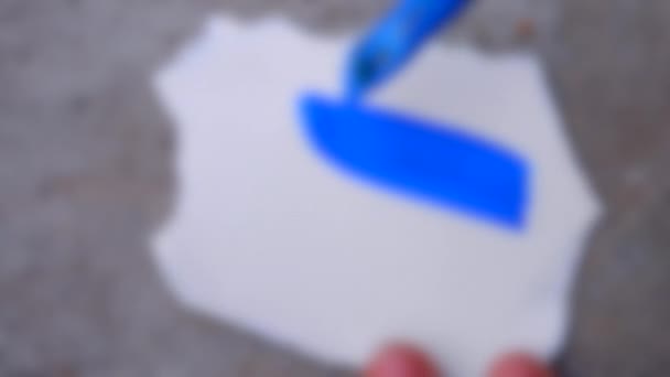 Blurred background. blue paint brush coating white surface close-up. — Stock Video