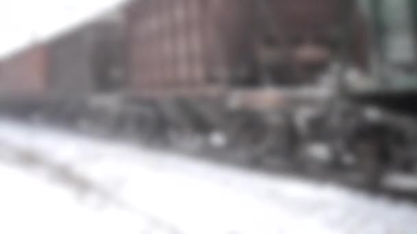 Zamazane tło. Jazda pociągiem po szynach zbliżenie w zimie. Samochody towarowe — Wideo stockowe