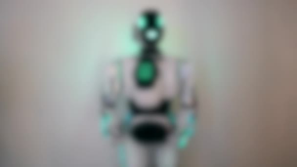 Blurred background. The robot is moving. Robot raises his hands and bends — Stock Video