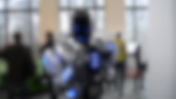 Blurred background. Man in Robot Costume communicates with visitors — Stock Video