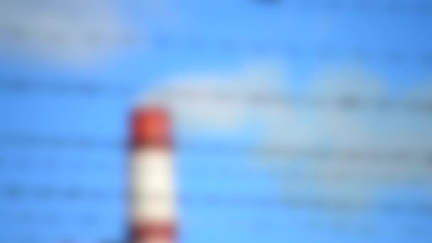 Розмитий фон. Колючий дріт і труба з димом, фон блакитне чисте небо — стокове відео