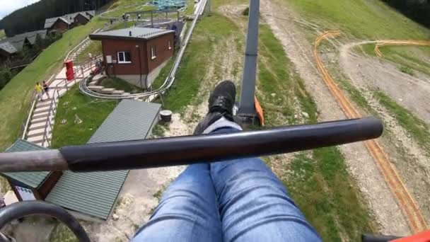 Girl rides or climbs on lift or cable car up mountain. — Stock Video