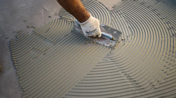 cementitious adhesive applied to the floor ready to receive the ceramic tile