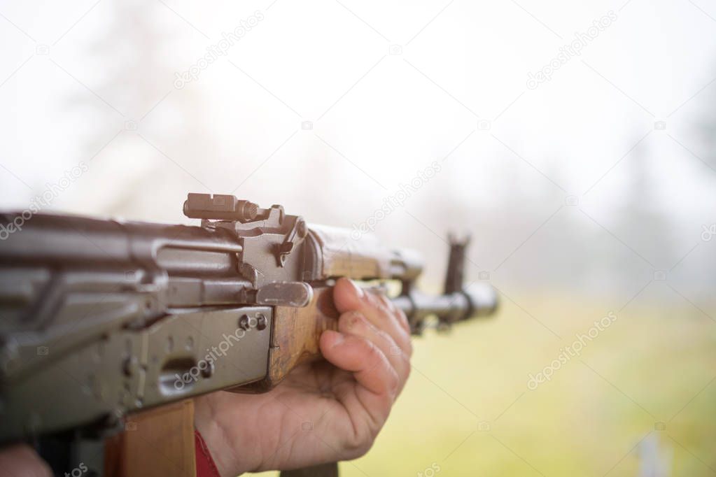 Man hands and Russian machine gun fire closeup