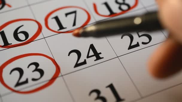 Подписание дня в календаре красной ручкой — стоковое видео