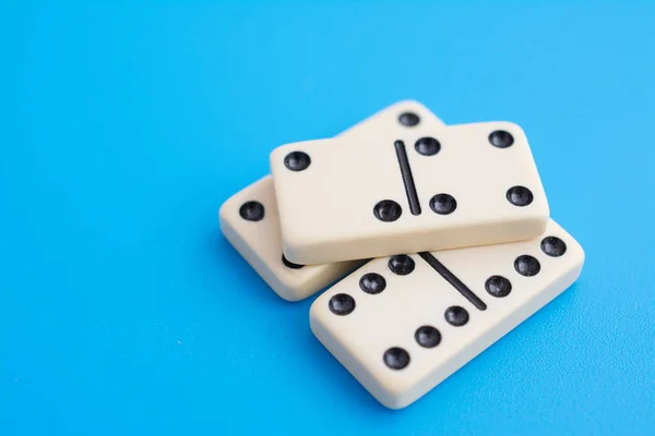 Playing dominoes on a blue