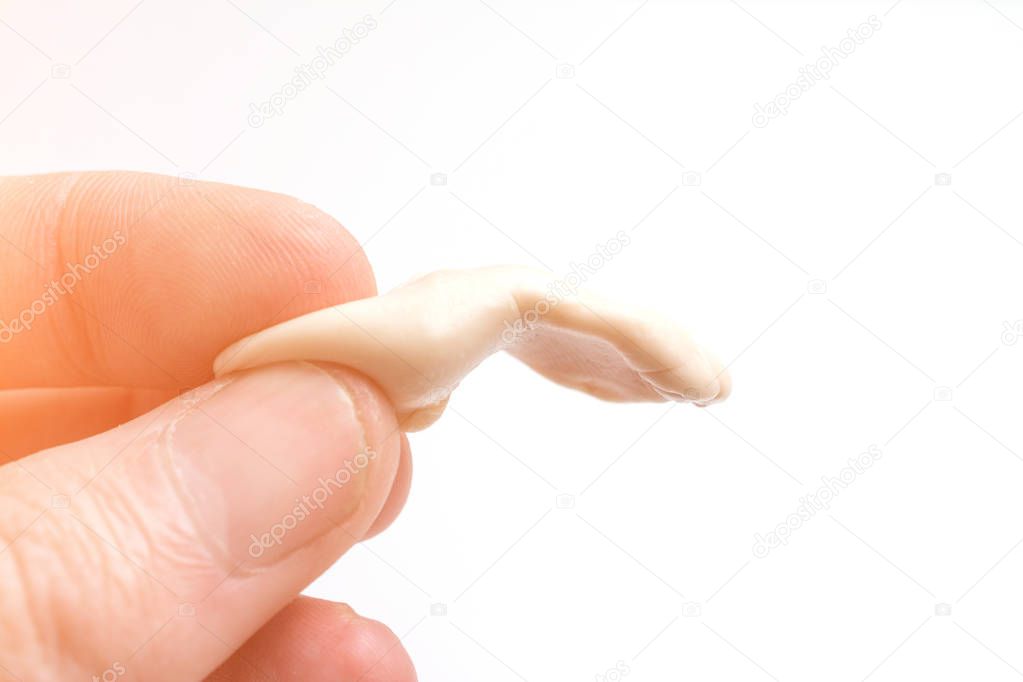 man holds hand in chewing gum isolated on white background