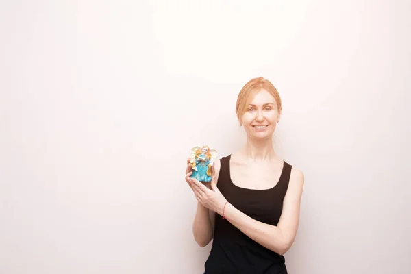 Beautiful angel figurine woman hands hold over white background