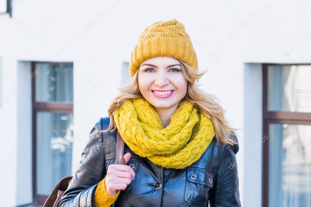 Portrait of happy smiling woman standing on the square on sunny summer or spring day outside, cute smiling woman looking at you, attractive young girl enjoying springs time