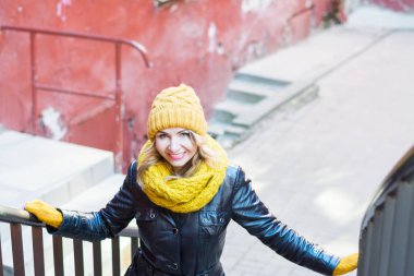 stylish girl portrait looking into the camera on an old street