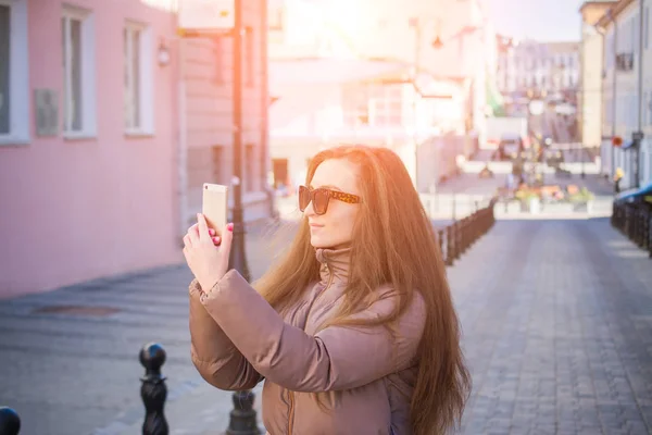 City lifestyle concept, young girl makes selfie