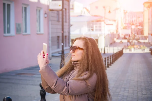 City lifestyle concept, young girl makes selfie