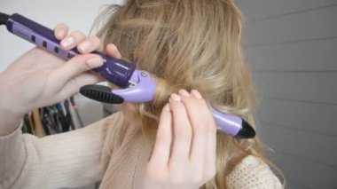 Genç sarışın kadın saç maşa üzerinde Curling