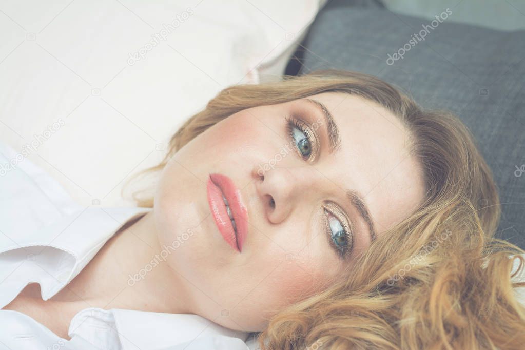 Portrait of beautiful caucasioan blonde hair woman sleep lying in bed with head on pillow comfortable