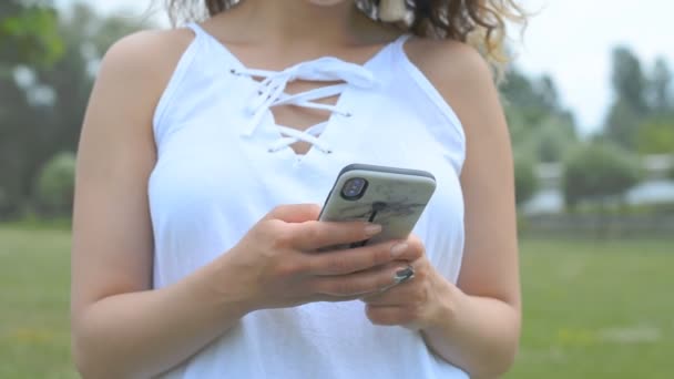 Closeup of young woman hands typing sms — Stock Video