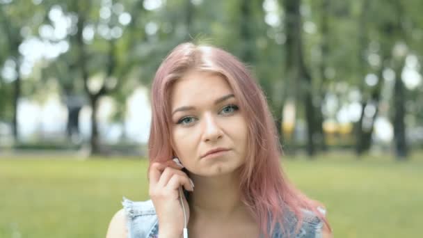 都市公園で赤い髪をした若いヒップスターの女の子の肖像画 — ストック動画