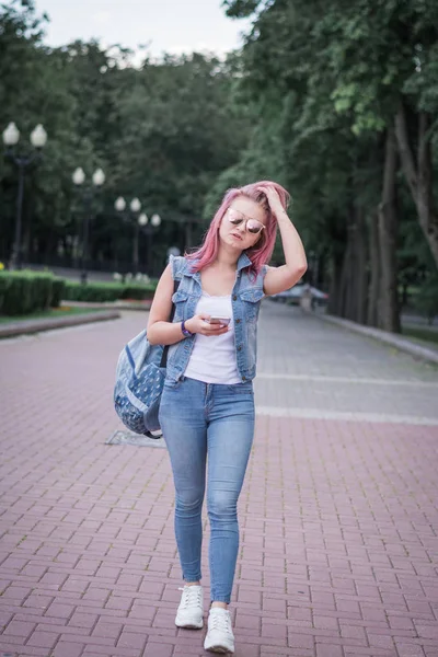 도시 공원에서 거리에서 걷는 스마트 폰을 사용하여 현대적인 헤어 스타일을 가진 젊은 도시 여성 — 스톡 사진