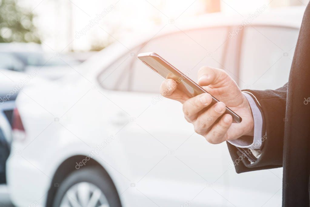 close shot of the hand of a businessman who is doing something in his phone