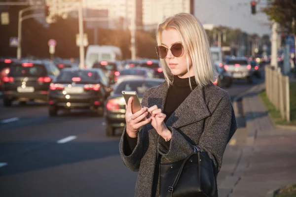 Woman using phone app for taxi ride hailing service or using phone app to find directions and guide during travel