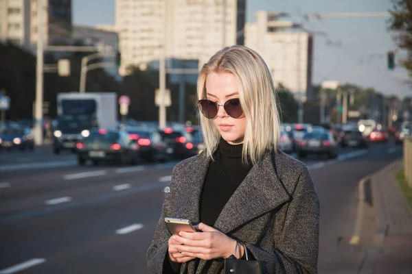 Woman using phone app for taxi ride hailing service or using phone app to find directions and guide during travel