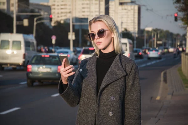 Woman using phone app for taxi ride hailing service or using phone app to find directions and guide during travel