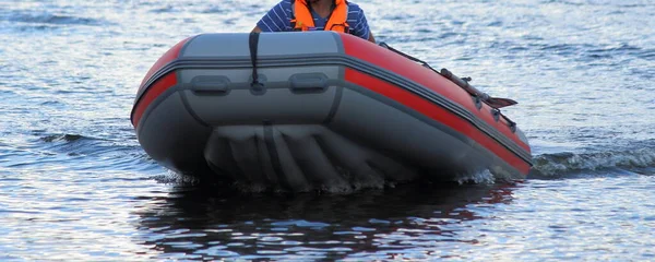 Gray red modern PVC motor boat with low pressure inflatable floor bottom floating on water, front view close up — Stock Image Gray Red Modern Pvc Motor Boat Low Pressure Inflatable Floor Stock Picture