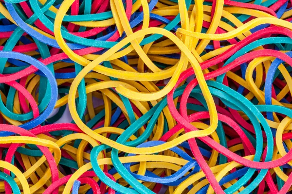 Multicolored bright elastic rubber band colorful background in a stack heap stock photo heap