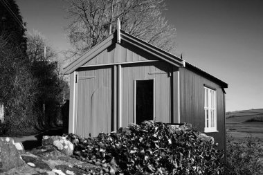 Monochrome image of Dylan Thomas poet writer writing shed Laugharne Carmarthenshire South Wales a popular Welsh travel destination tourist attraction landmark stock photo clipart