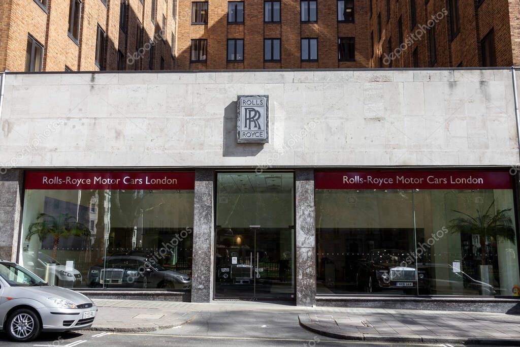 London, UK, April 1, 2012 : Rolls Royce sign advertising logo at their car showroom dealership a business selling luxury cars and SUVs and a stock photo image