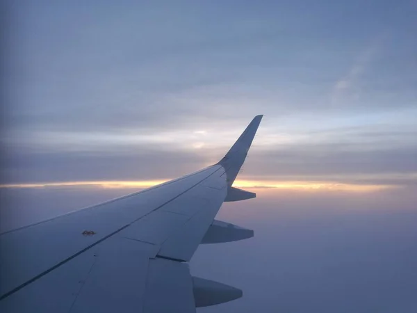 A asa de um avião com um fundo nublado — Fotografia de Stock