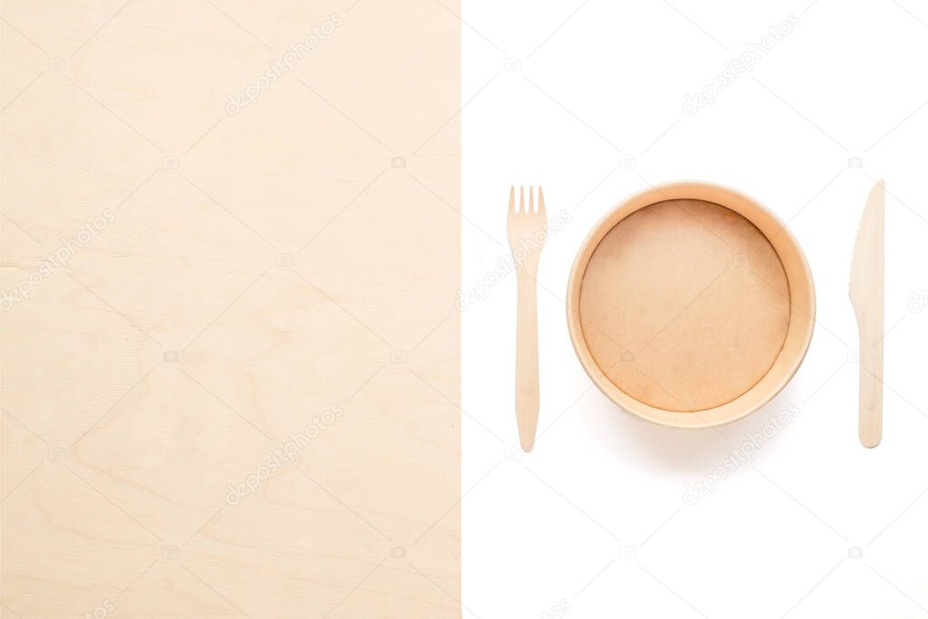 Zero waste concept. paper plate and wooden fork and knife isolated on a white background. Plastic rejection. copy space.