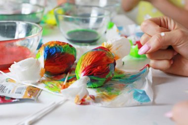 Paskalya için peçetelere yumurta boyamak, el yapımı soyut resim, evde otururken, bir güney evi, sanat terapisi