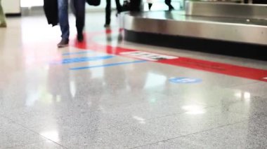 Havaalanına gelen yolcular bagajlarını bekliyorlar.