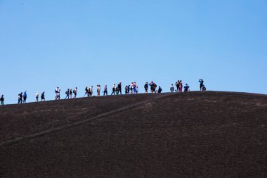 group of tourists on the ridge of Mount Etna's crater. Traveling in Italy