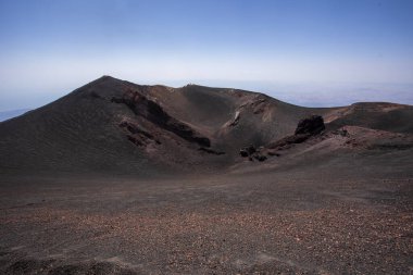 huge crater with volcanic rocks on Mount Etna. Traveling in Italy