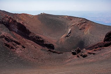 View of the huge crater of Mount Etna with a bus route for tourists to the peak