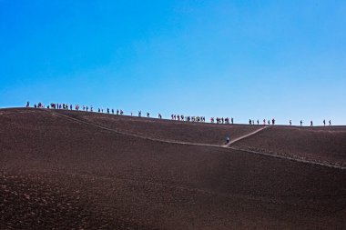group of tourists on the ridge of Mount Etna's crater. Traveling in Italy