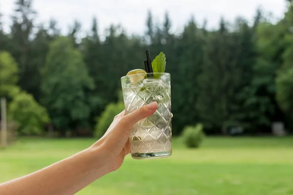 Glas Mojito in weiblicher Hand — Stockfoto