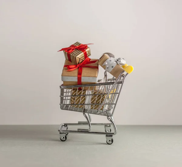 mini shopping cart with boxes with presents