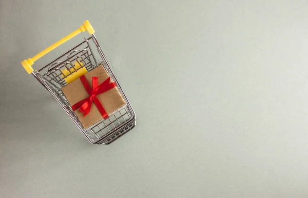 mini shopping cart with boxes with presents