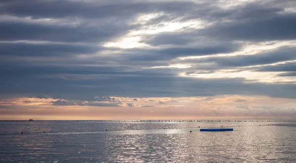 Cloudy sunset over adriatic sea surface — Stock Photo, Image