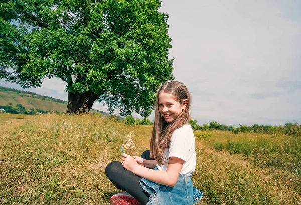 Dziewczynka Siedzi Pozycji Jogi Trawniku Relaksuje Się Tle Pięknej Wsi — Zdjęcie stockowe