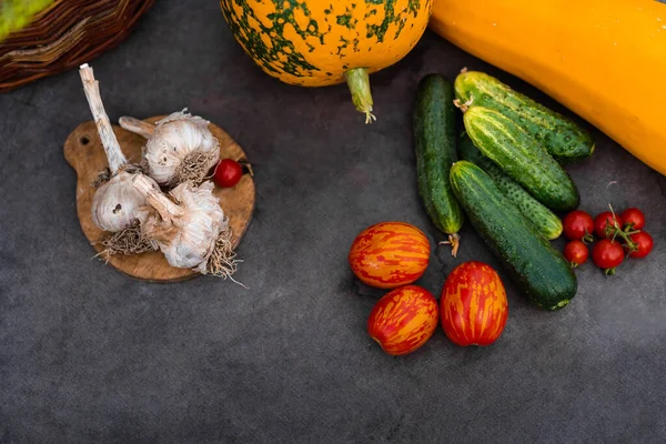 Vegetable collage as a background on a dark table. Seasonal fresh vegetables from the garden