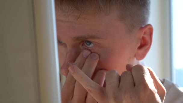 Young Man Looks Mirror Puts Contact Lens — Stock Video