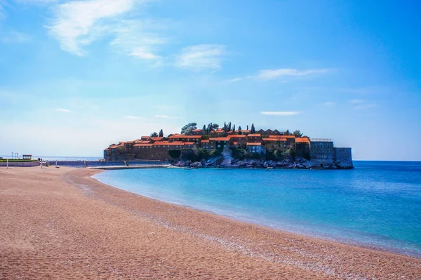 Mediterranean turquoise sea and coastline with small orange pebbles. St. Stephen\'s Island