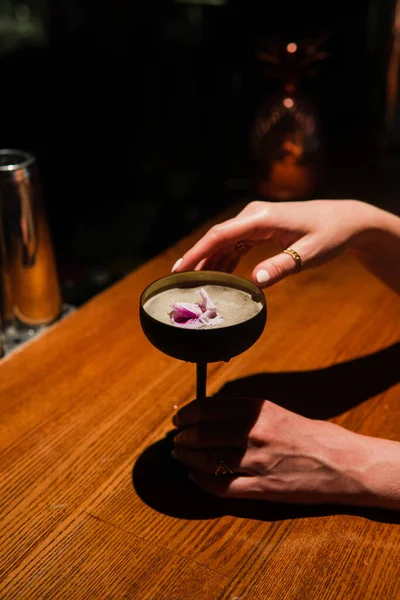 Alcohol cocktail with female hands on the dark background — Stock Photo, Image
